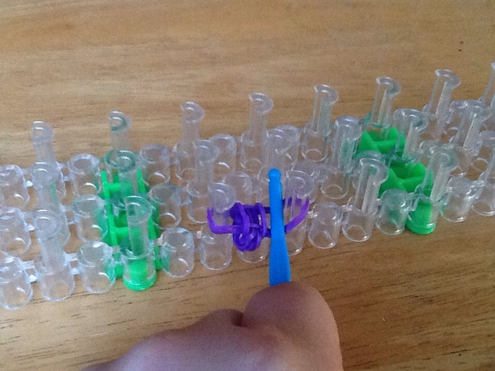 Push it down with the other end of the hook or with your finger.