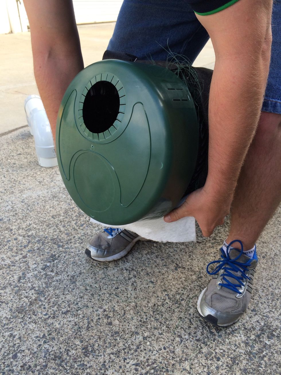 Push on firmly and roll fabric back over adaptor cap making sure that the 100mm hole is located at the top of the pipe.