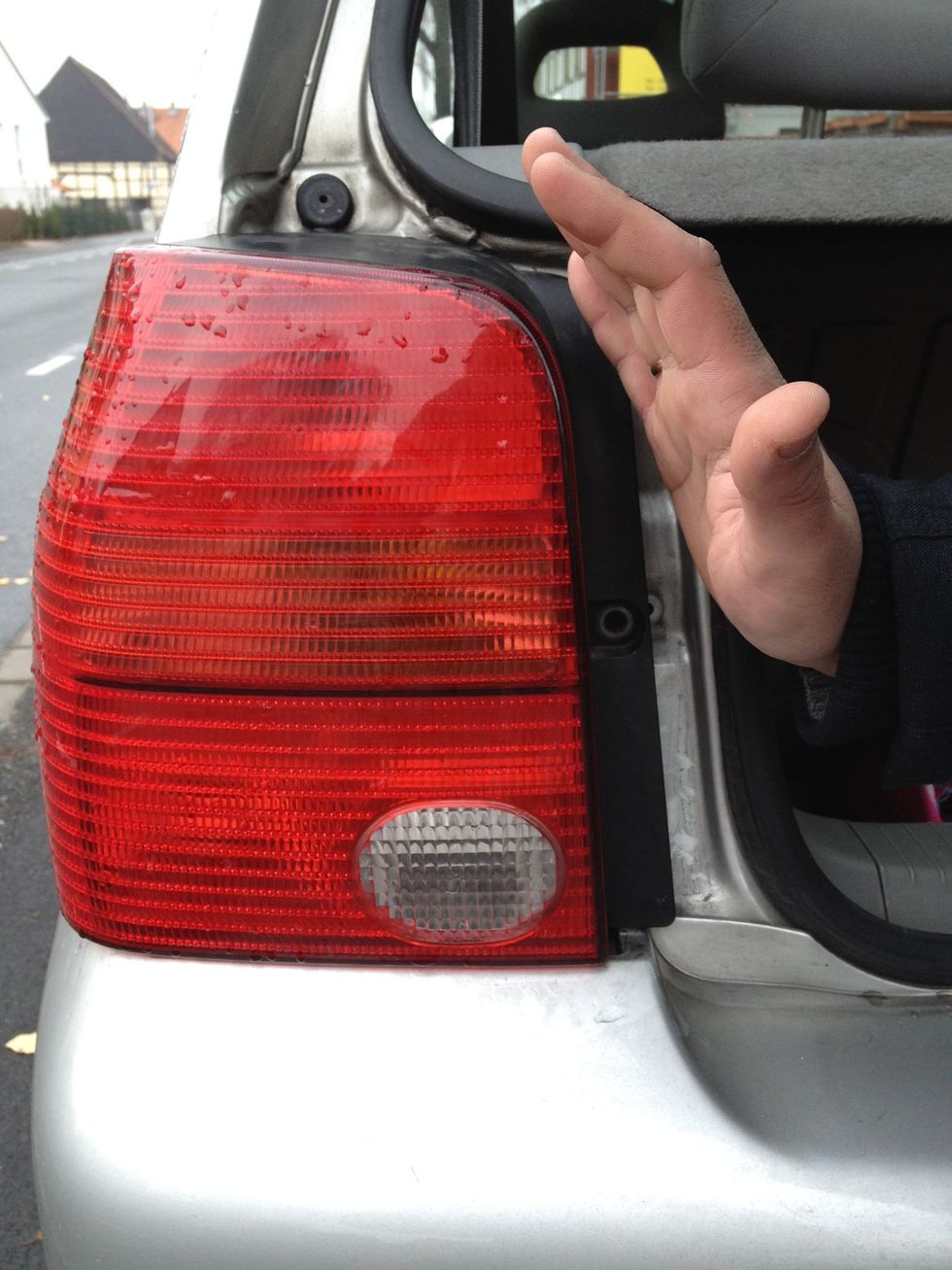 Push (or gently hit) the enclosure until it pops out. For the left light: push from right to left. For the right light: from left to right.