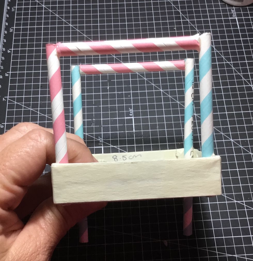 Push the back cart uprights through remaining holes, be sure to keep level with the underside of the base of the cart and glue in place as shown. Then attach the roof frame piece as shown.