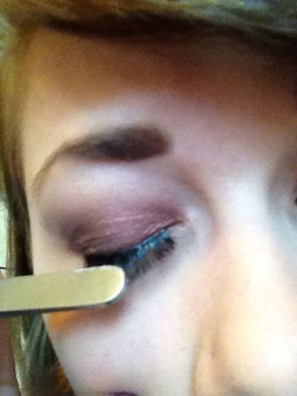 Push the edge of the tweezers against the lash line
