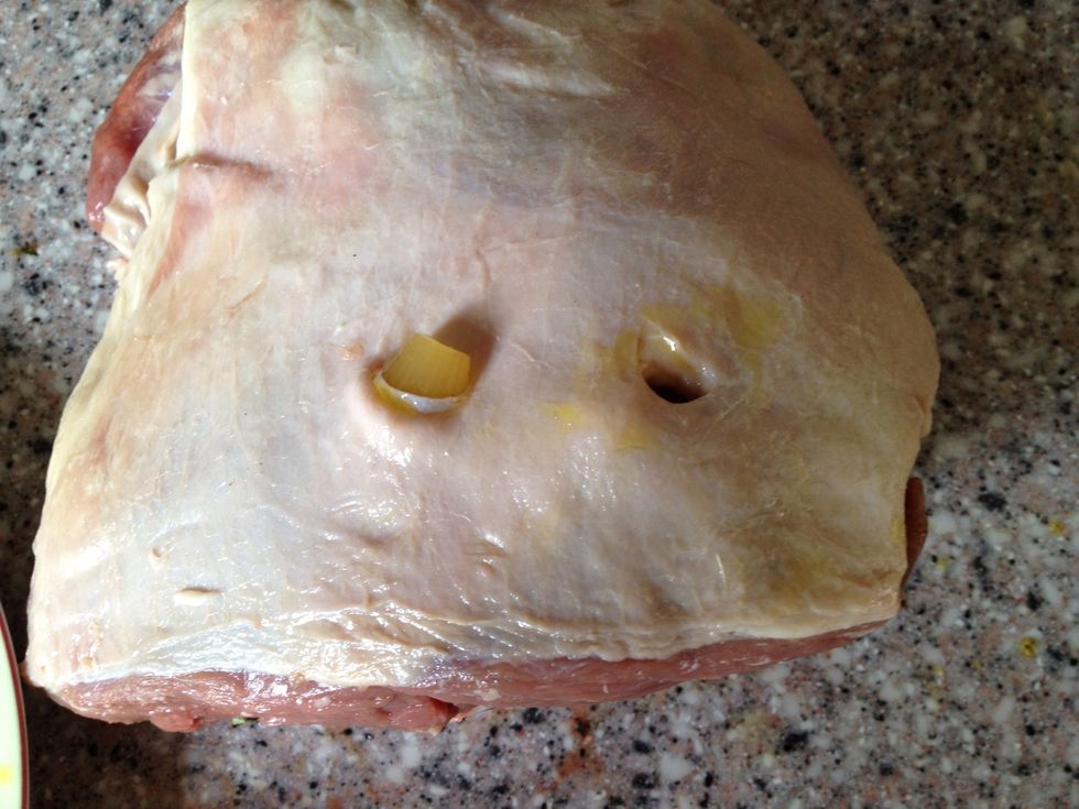 Push the garlic cloves into the meat, try to spread them evenly around the meat