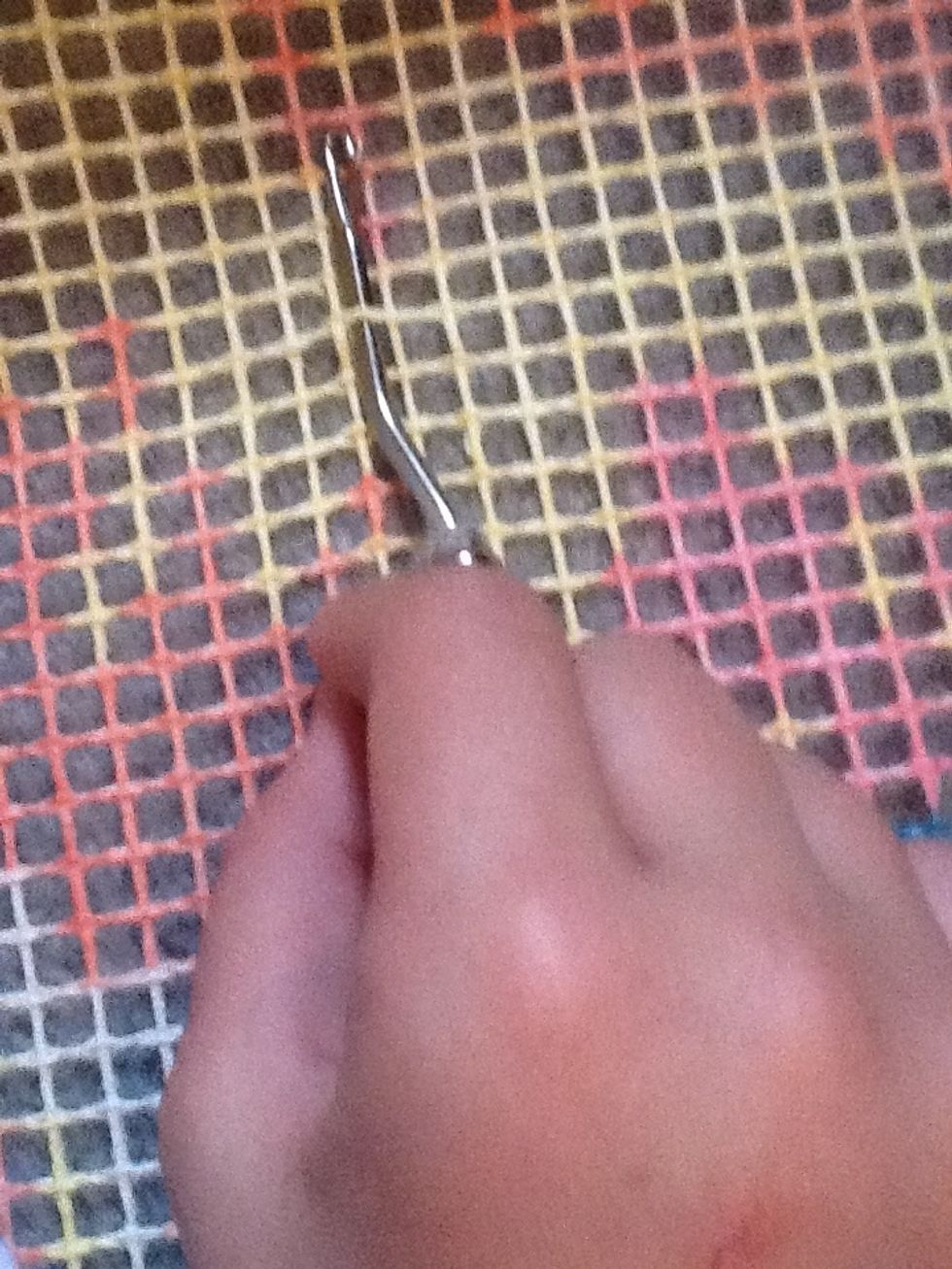 Push the hook under one of the grid strings