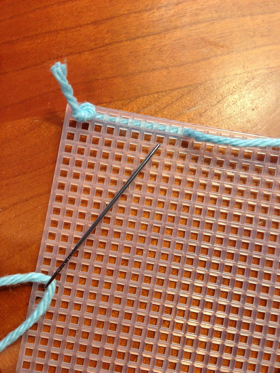 Push the needle back up through the canvas where you want to start the stitch. A piece of yarn will be on the bottom side.