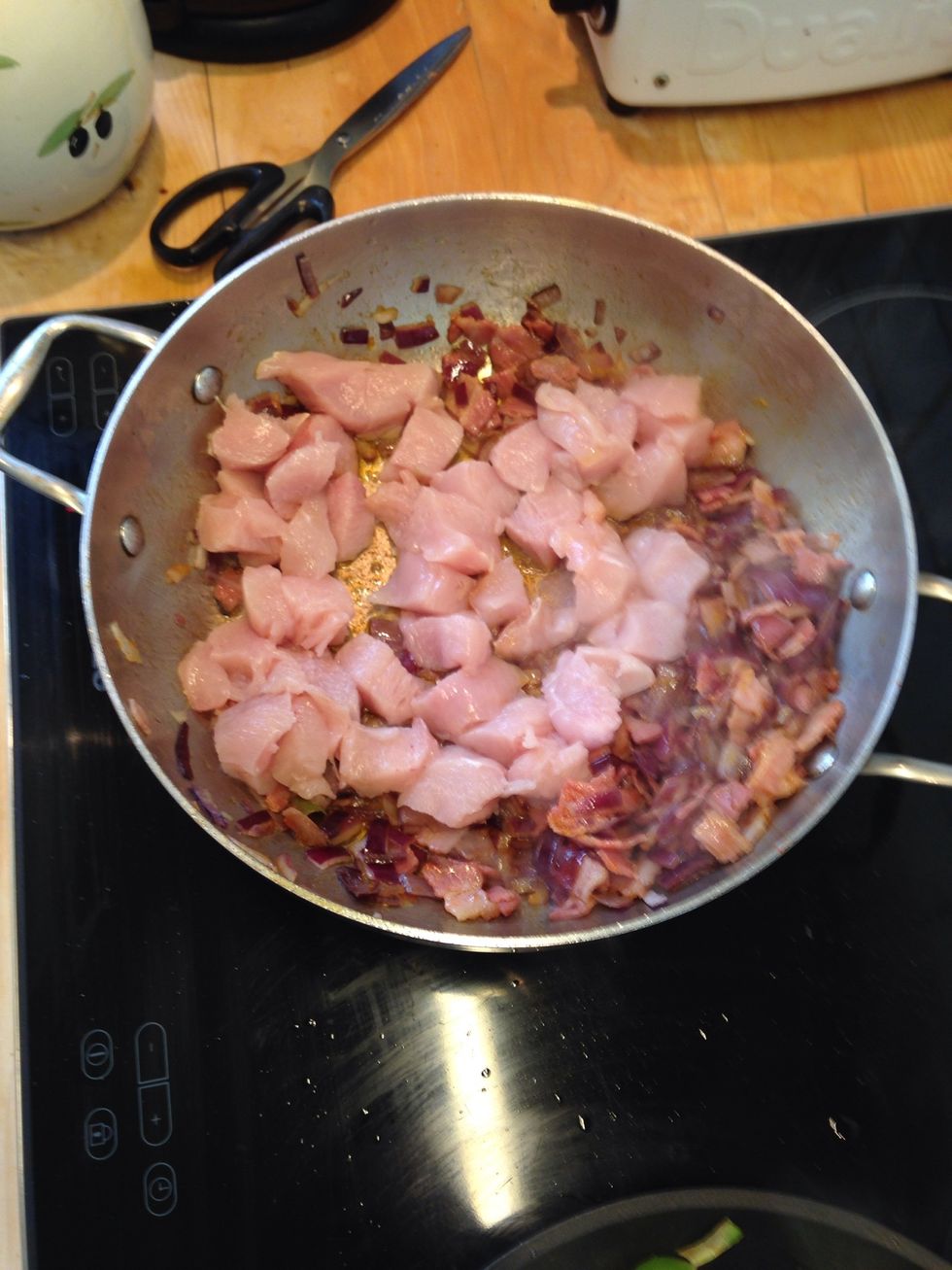 Push the previous onions and bacon to a side and let the chicken cook