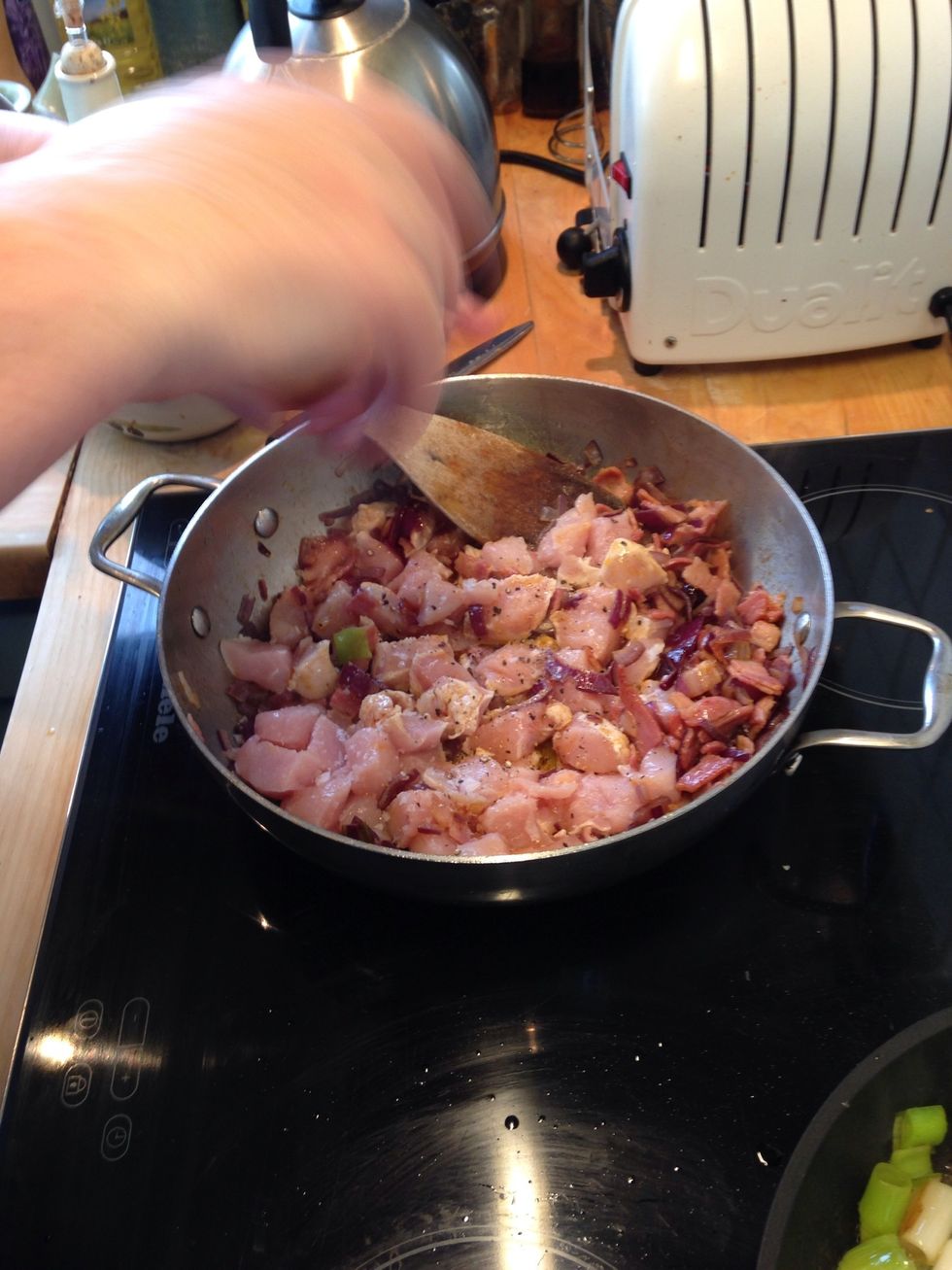 Push the previous onions and bacon to a side and let the chicken cook