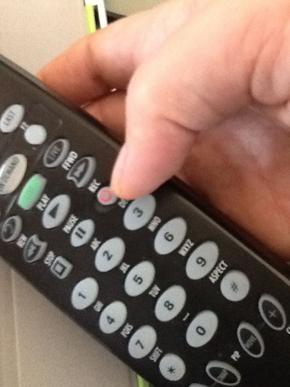 Push the red record button located on your remote.
