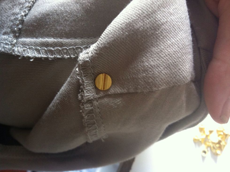Push the stud backing through the hole, making sure the screw side is on the front. Then, simply tightly twist the cone on.