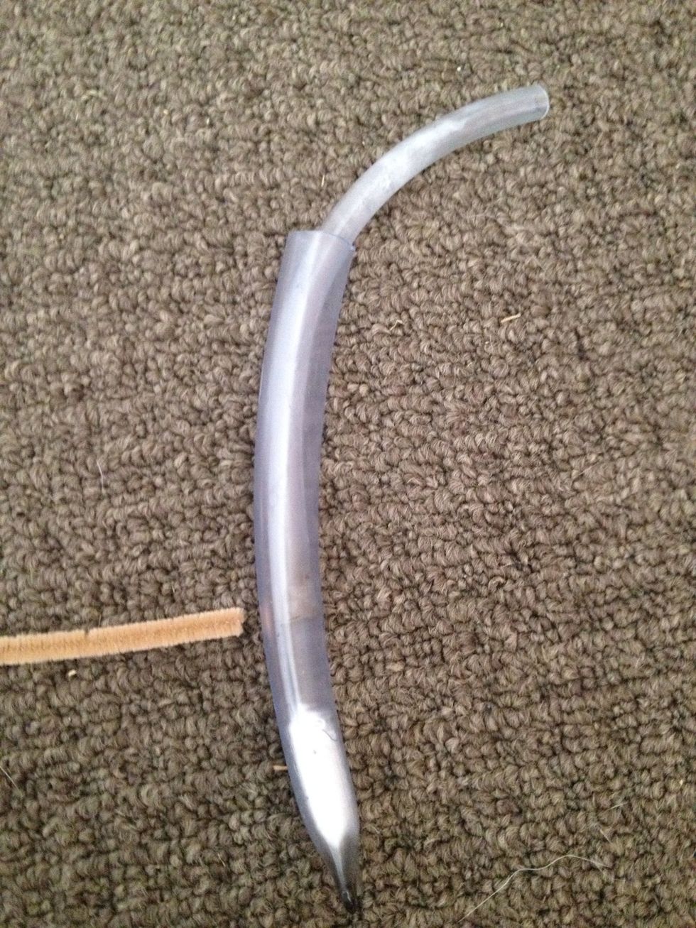 Push the stuffing to the sealed end then draw up the inner hose to where the pipecleaner is