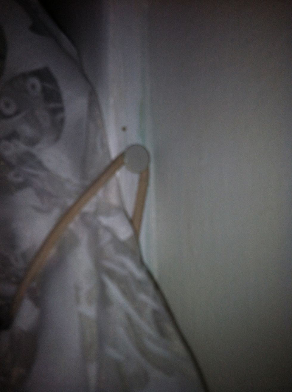 Push thumbtack into window frame, off to the side so it cannot be seen