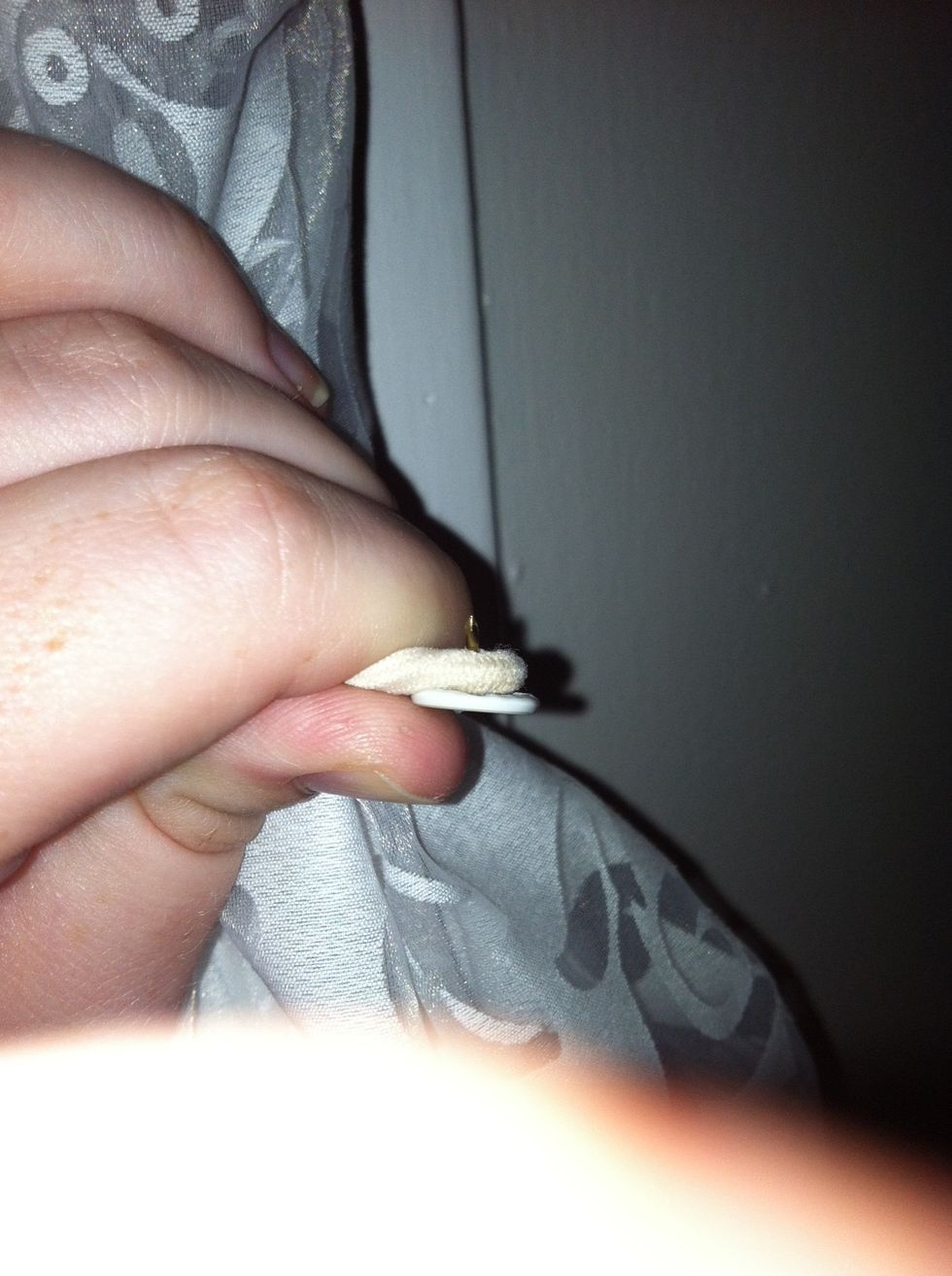 Push thumbtack thru hair elastic