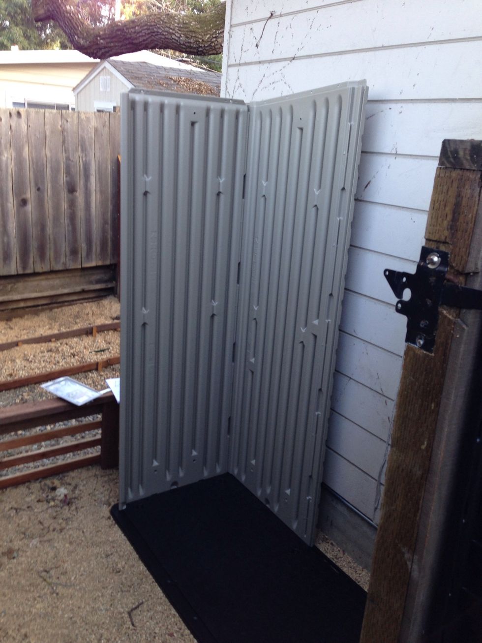 Push wall down into the slots until it clicks.