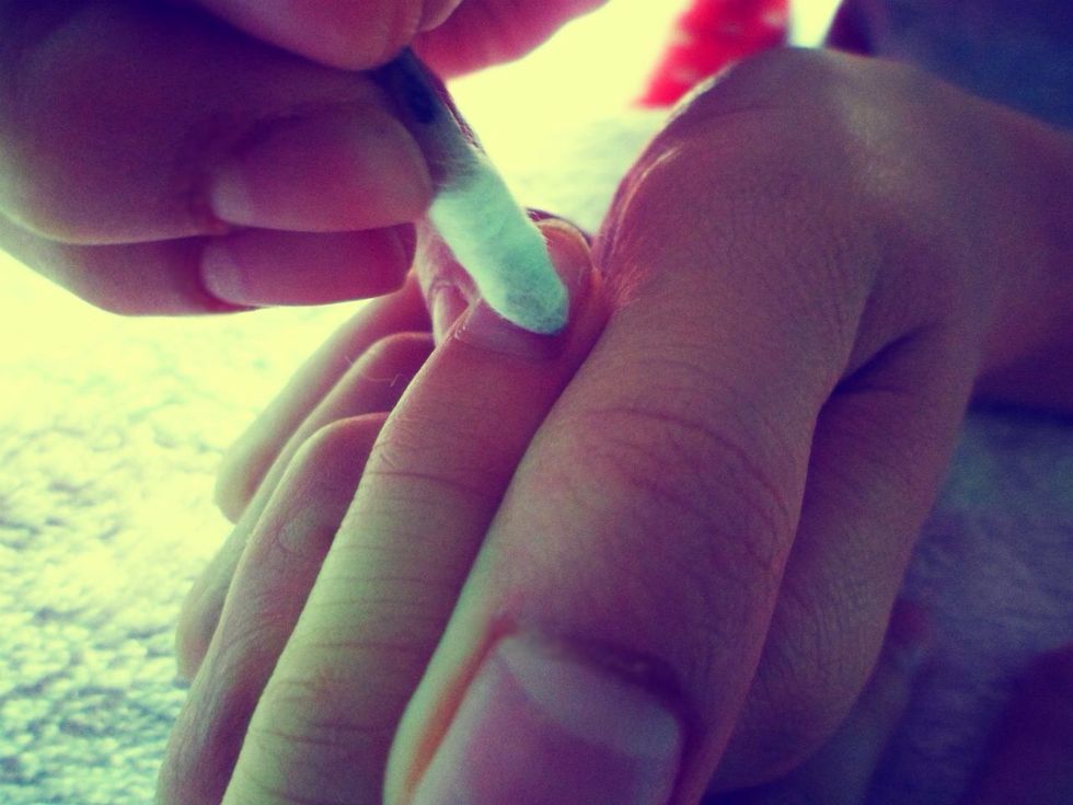 Push your cuticles in with a circular motion using the cotton-wrapped cuticle stick. The cotton will remove any dirt under the cuticles as you push them in.