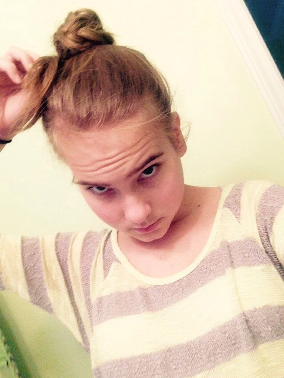 Pushing the hairband underneath the bun