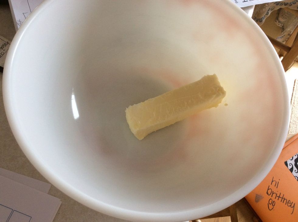 Put 1/2 cup (1 stick) of butter in one of the mixing bowls, and place it in the microwave on medium heat until softened. This usually takes 30 seconds.
