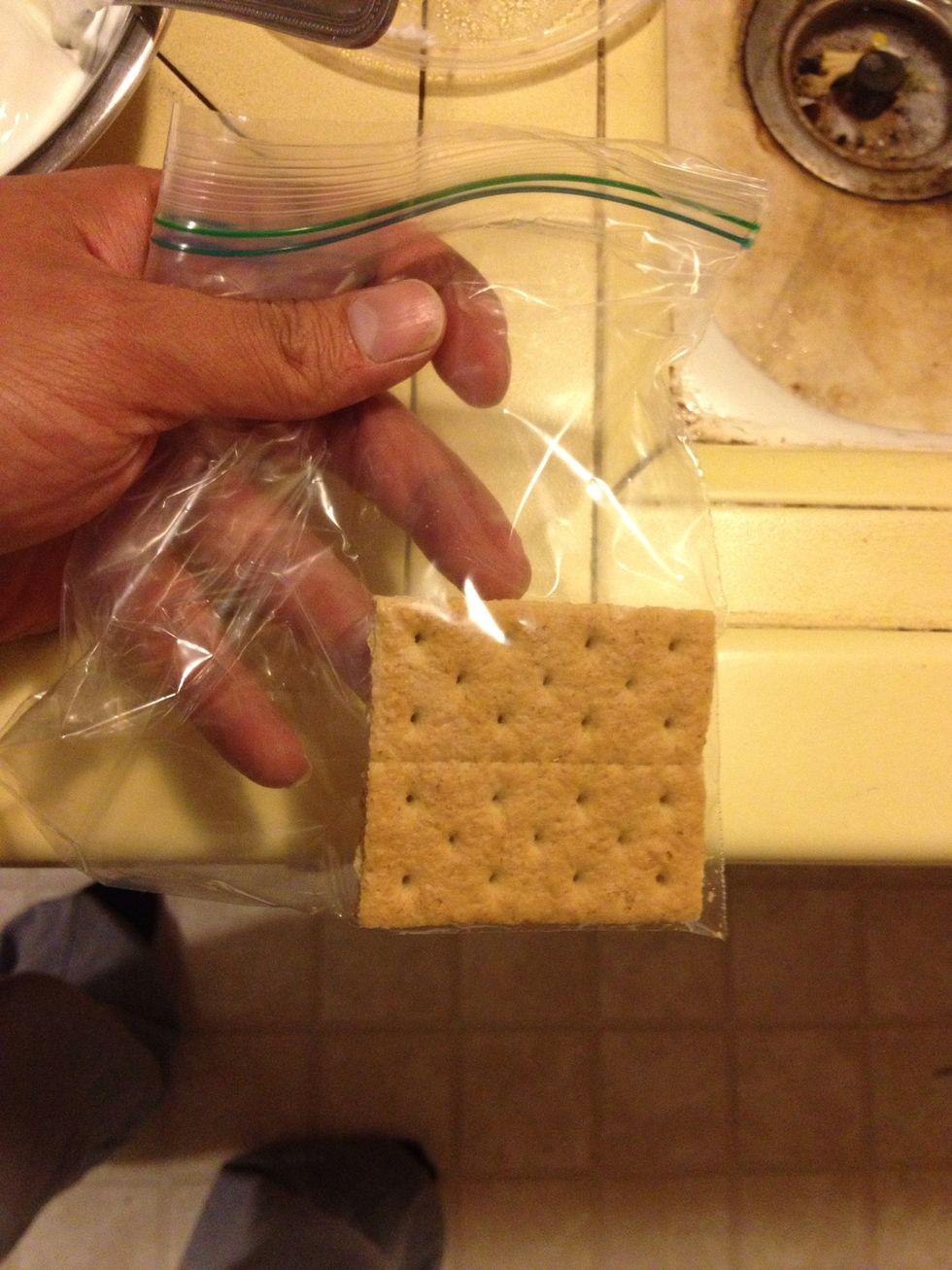 Put 1/2 of a graham cracker in a sandwich bag.