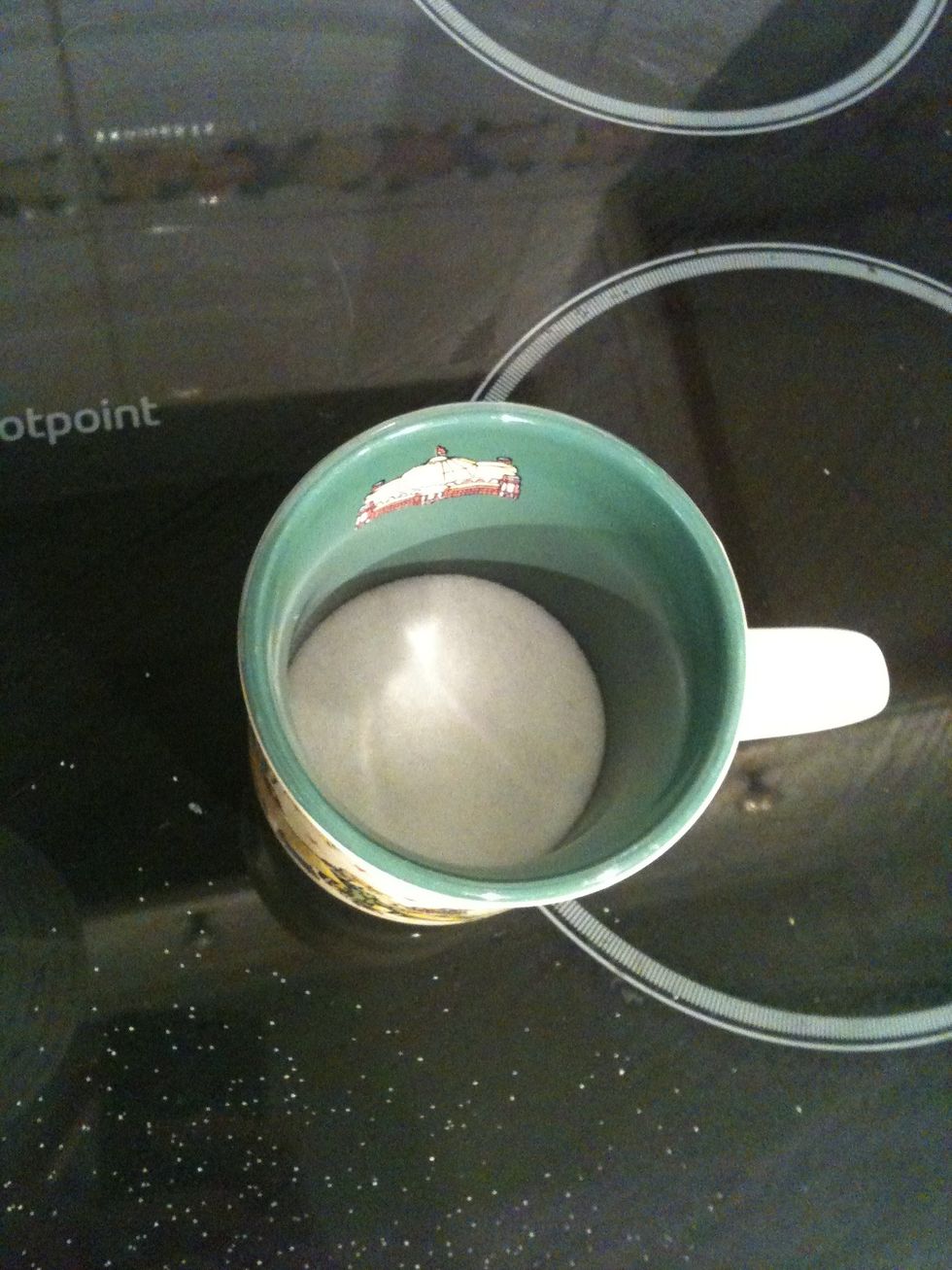 Put 1/4 mug of sugar in the mug.