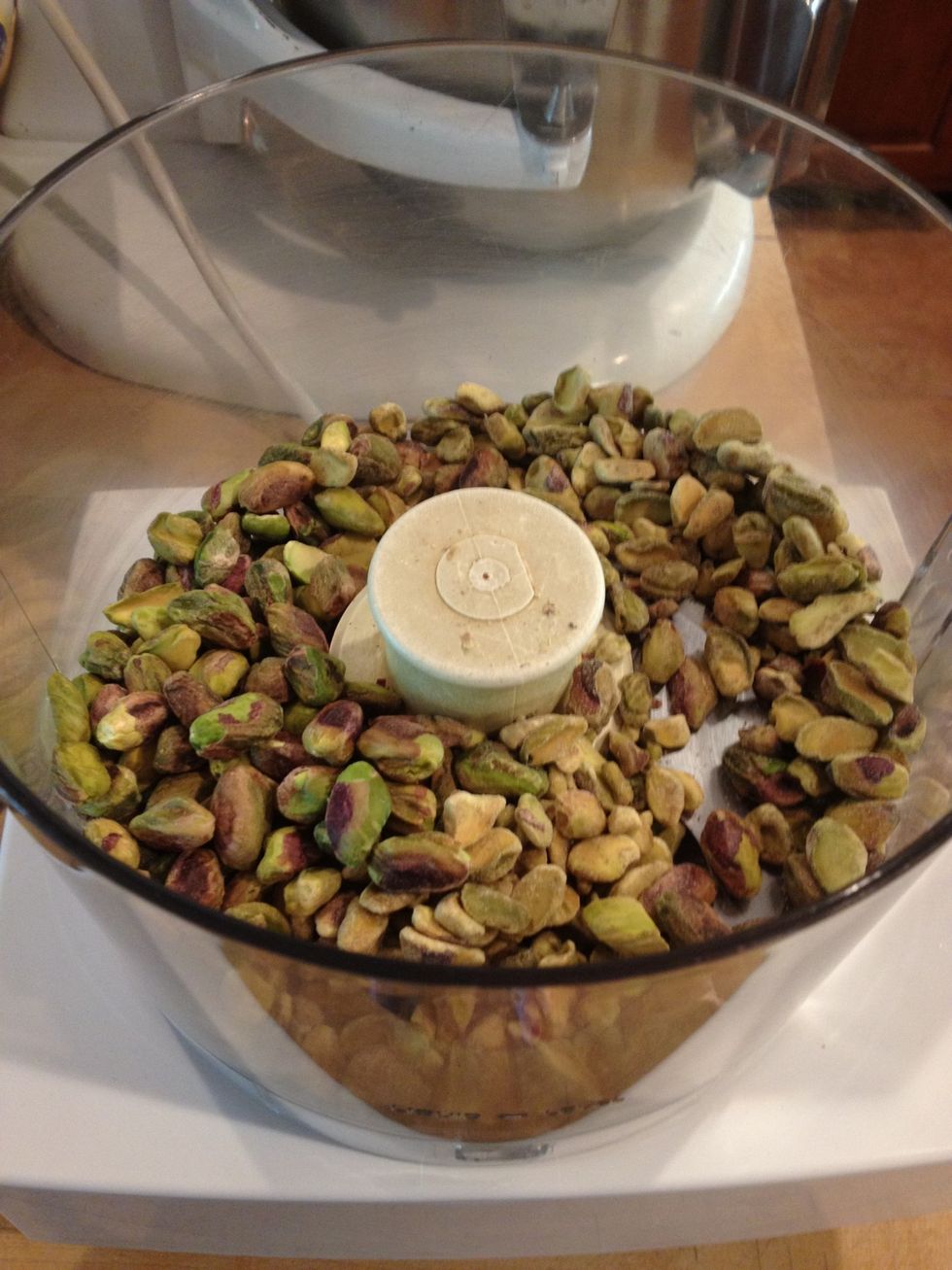 Put 1 and 1/2 cups shelled pistachios into a cuisinart.