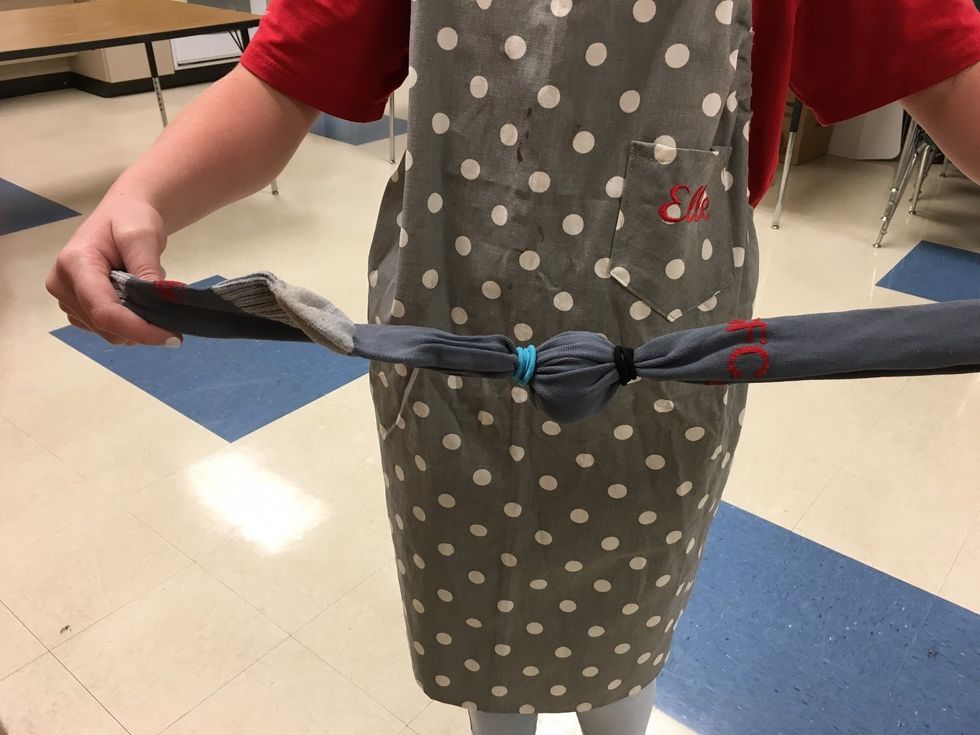 Put 1 large egg in the sock. Put the egg in the center of the sock. Then, using the string or rubber bands, tie the sock at each of the ends of the egg.