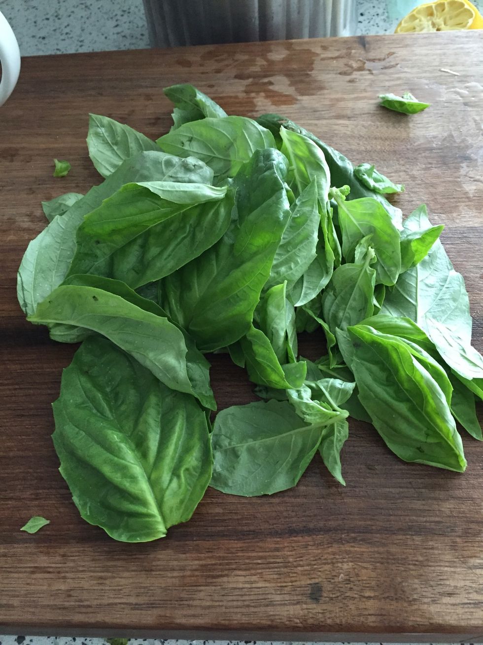 Put 2 cups of fresh basil leaves in food processor with steel blade.