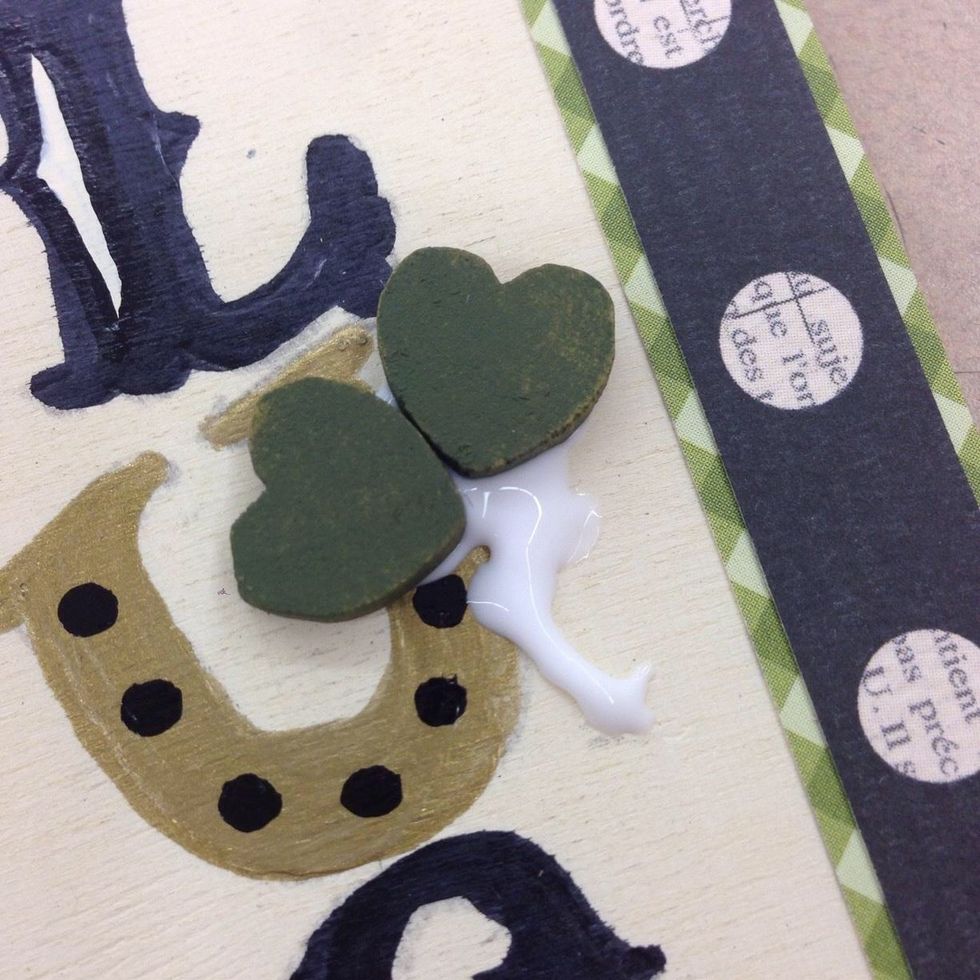 Put 2 hearts in place, then add a curve of Tacky Glue for the stem. The paint makes the jute flexible. Curve it gently and trim to the length you prefer. Lay it in place, then add the 3rd heart.