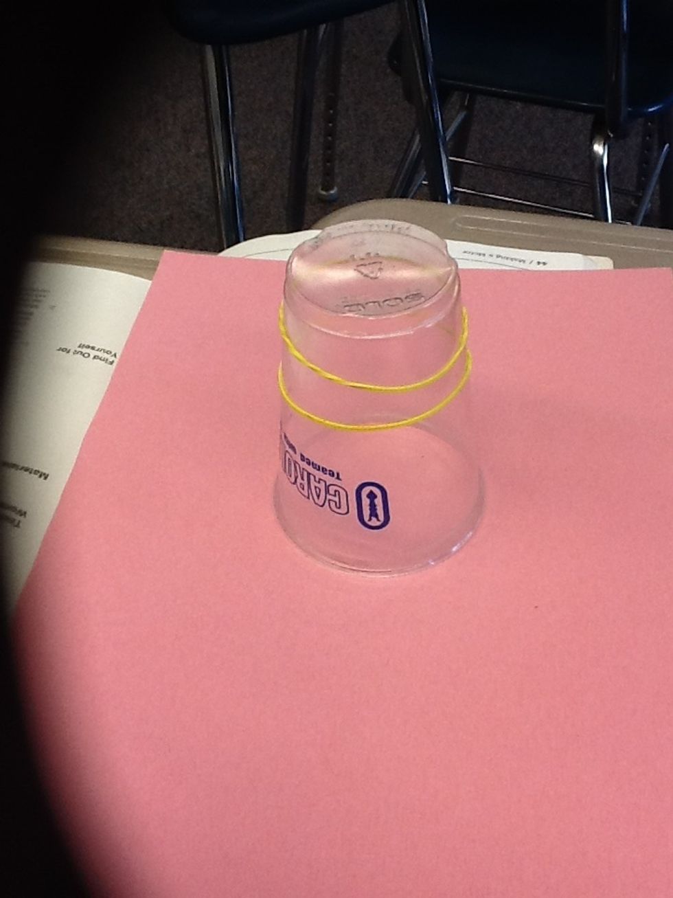 Put 2 rubber bands around the cup