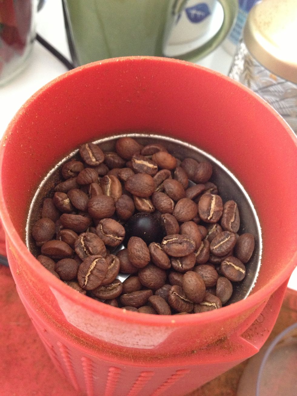 Put 24 grams of coffee beans in your grinder. Hand grinders are better but I'm a bit lazy so I use an electric grinder. If you don't have scales it's about too small scoops.