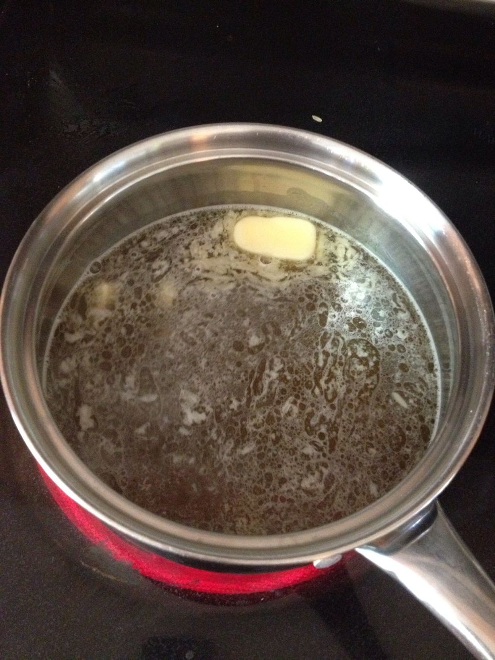 Put 3 1/2 cups of Vegetable stock and the other half of your stick of butter, or some olive oil into a pot. Set the burner on high to bring to a boil.