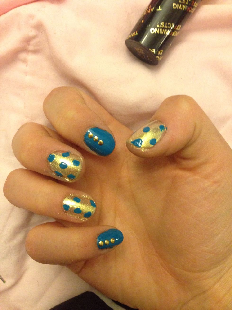Put 3 gold studs (or gold nail polish dots) on your blue nails going up in a line