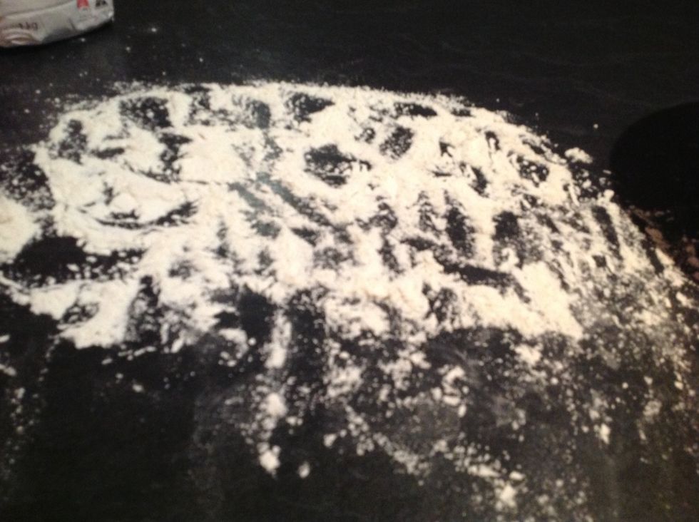 Put a bit of flour on the bench and spread it out