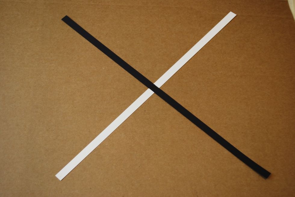 Put a black strip over the white one so that it will form an X.