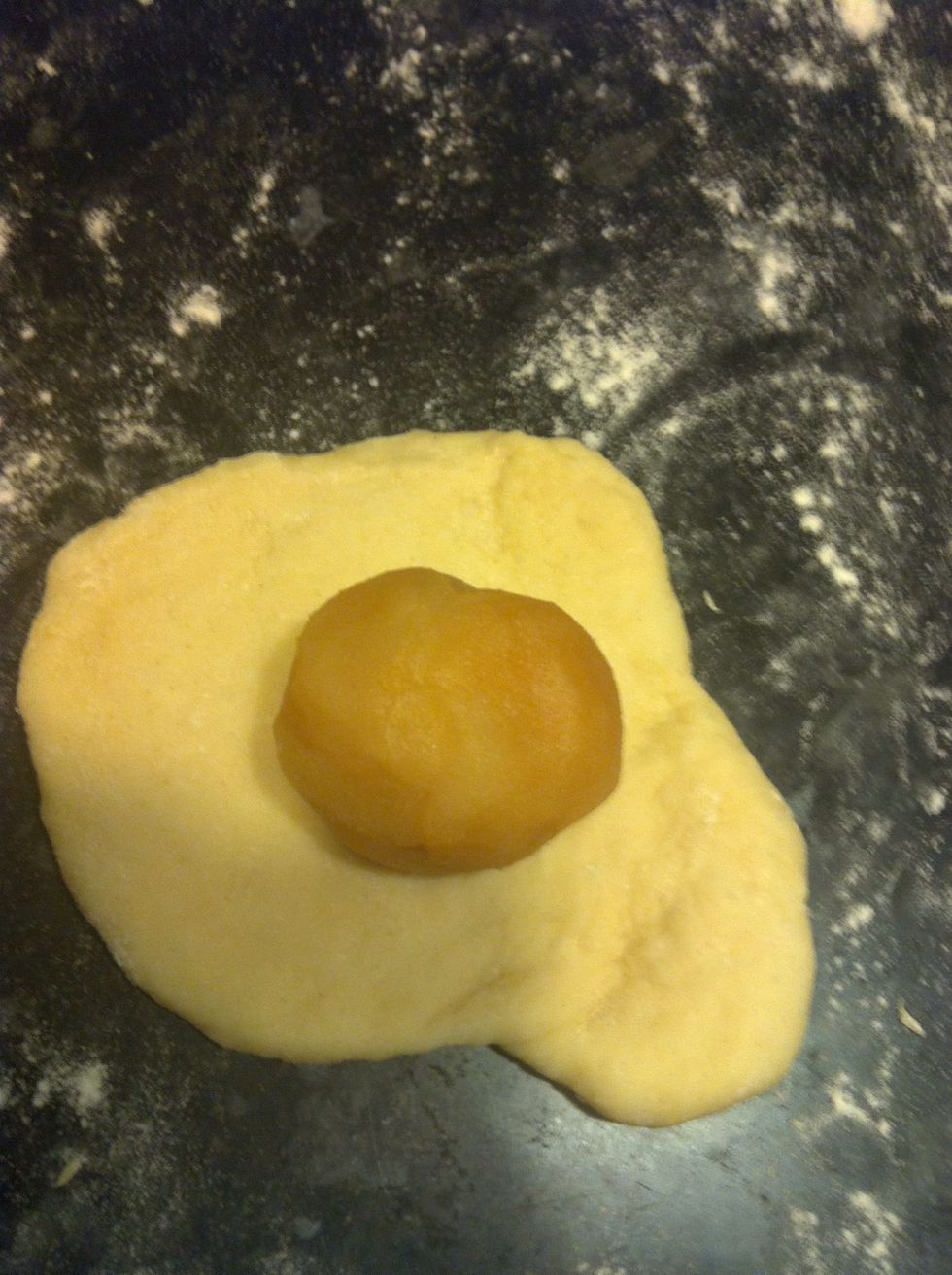 Put a blob of filling in... I suggest red bean paste or lotus paste. If you don't want filling then skip this step.