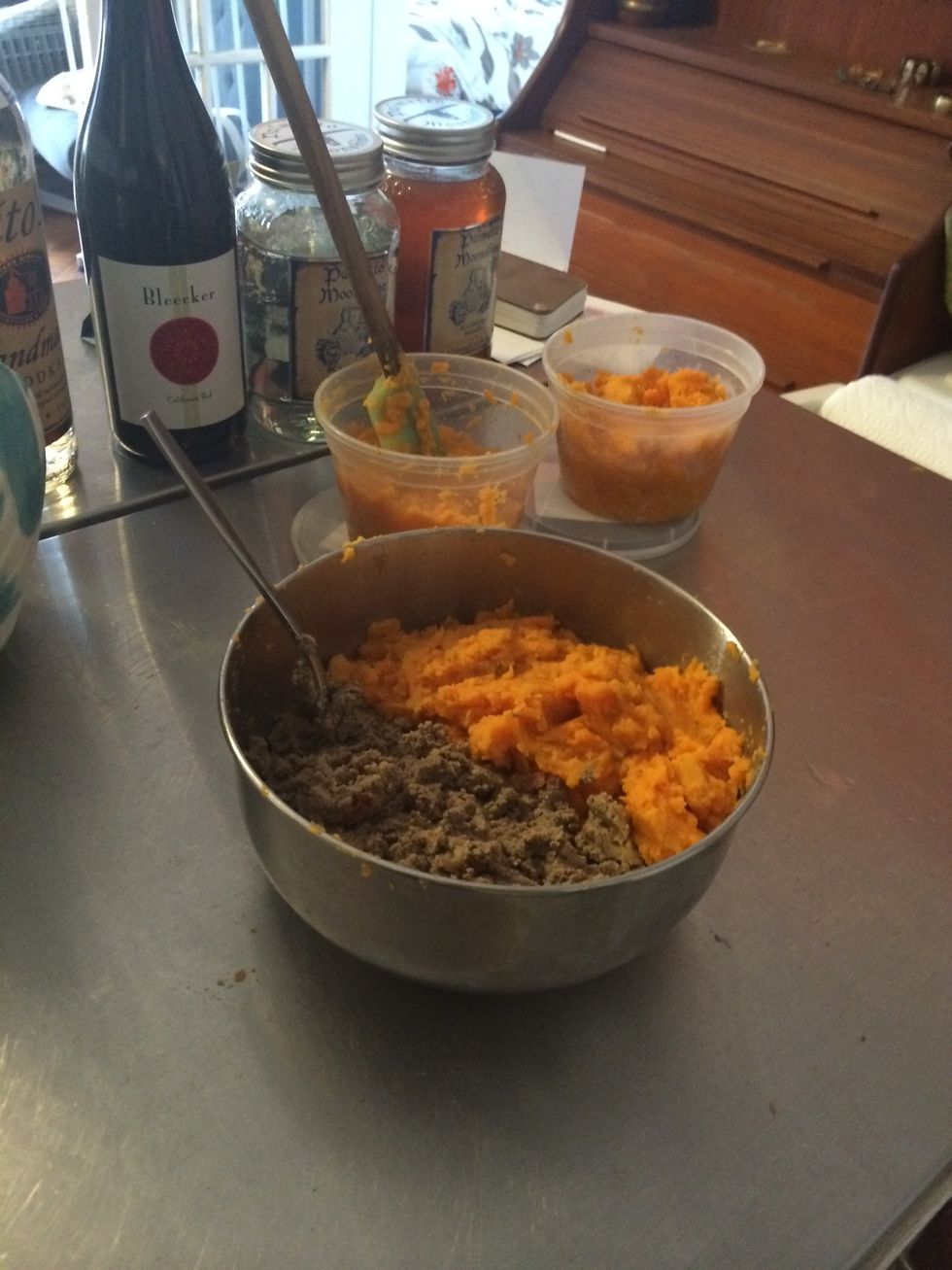 Put a can of your dog's regular wet food and an equal amount of sweet potatoes (approx 1) in a bowl and mix up. Put remaining potatoes in Tupperware.