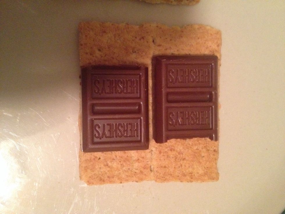 Put a couple of pieces of chocolate onto one side of your graham crackers.