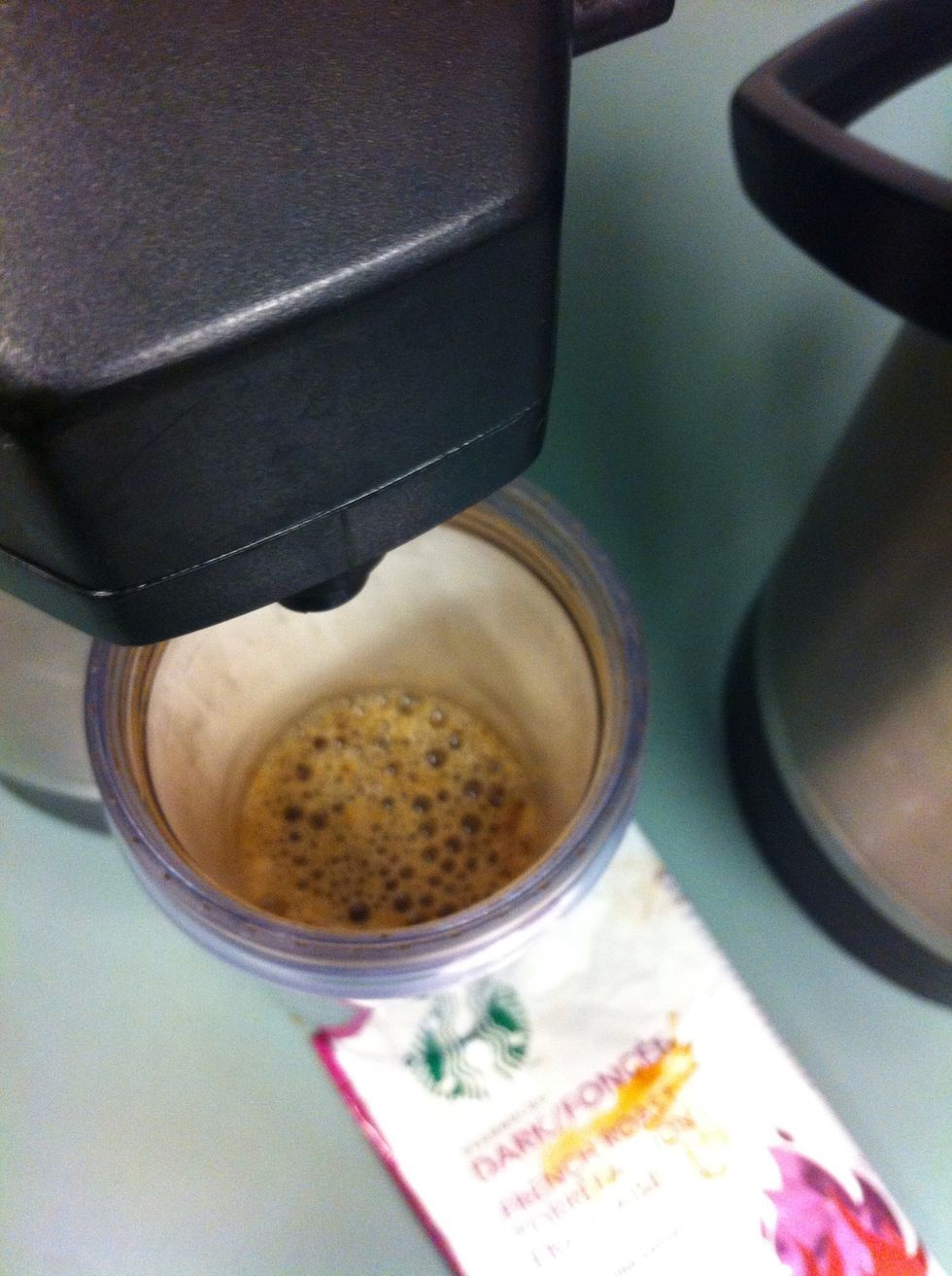 Put a cup of coffee or water into the cup,