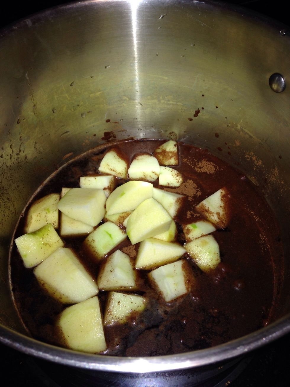 Put a cup or so of liquid, sugar (I'm using 2 cups of brown sugar) and spices (3 Tbsp of cinnamon for me) in a stockpot or Dutch oven. Turn the heat to high then turn to medium once it starts to boil.