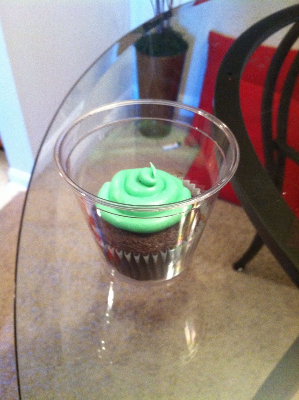 Put a cupcake in a plastic cup.