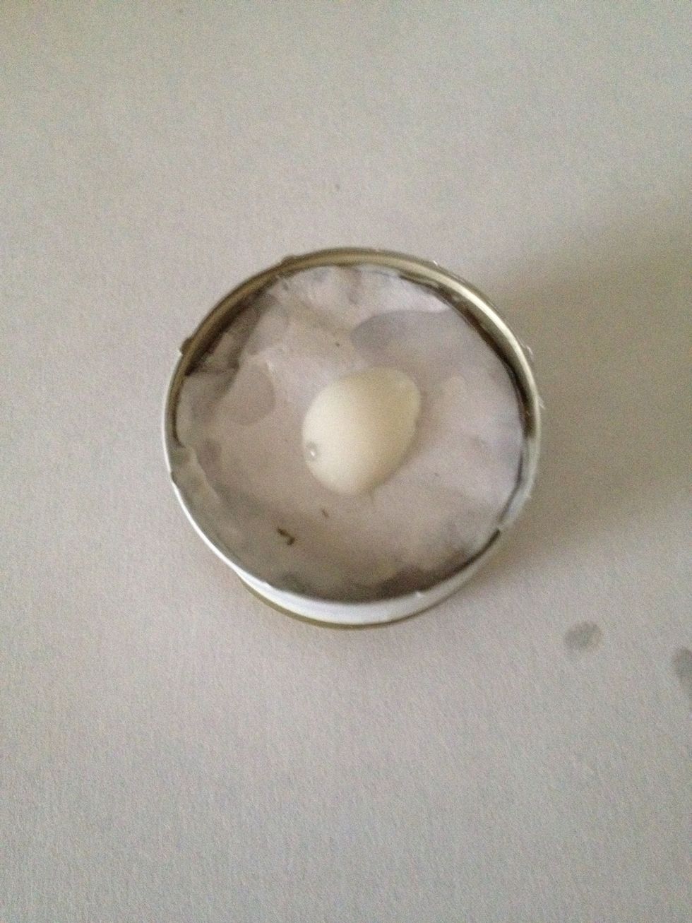 Put a dab of glue in the middle of your lid. (Paper I used to build up the height is underneath the glue. But the glue still works on the actual inside of the cap.)