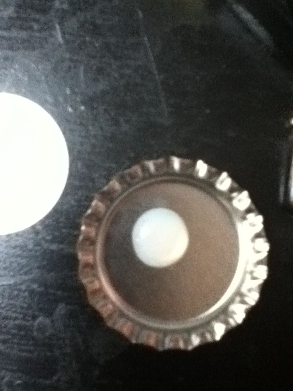 Put a dot of crystal lacquer in your bottle cap