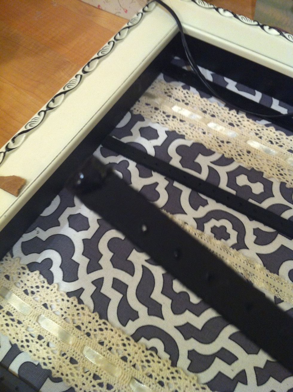 Put a drop of glue (I used strong shoe goo) on the edges of the wood sticks and place them on the inner rim of the frame