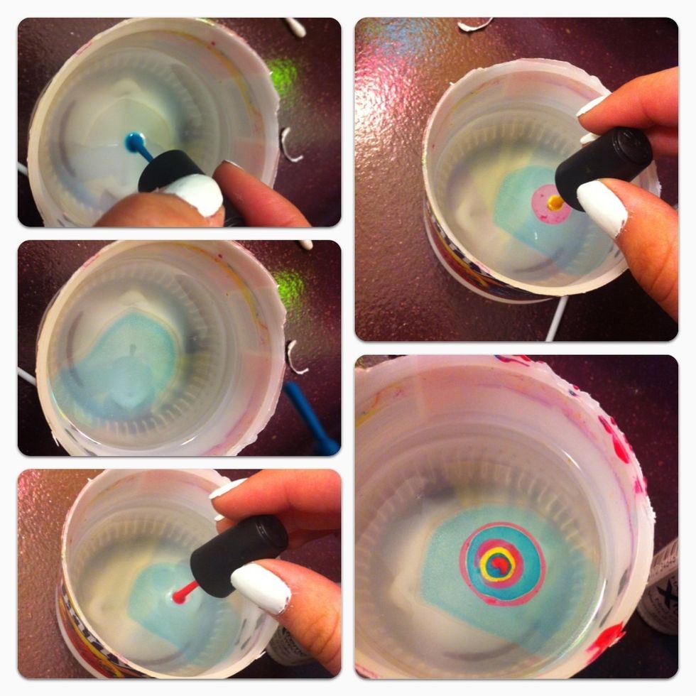 Put a drop of nail polish in the water, then the next color in the center, repeat this step until it looks like the last picture. With toothpick swirl around nail polish to make your design.