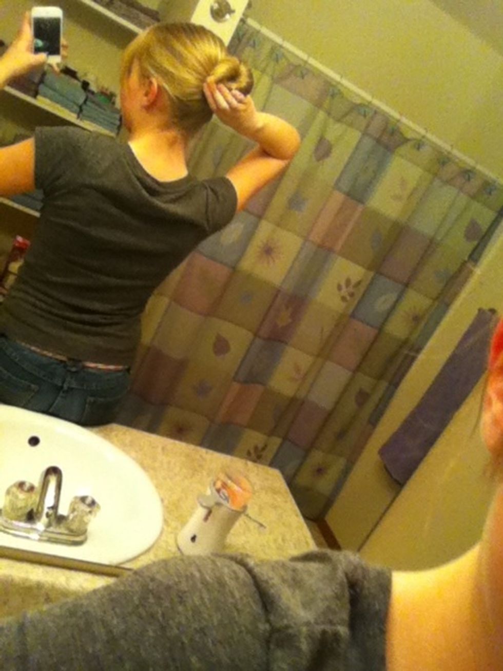 Put a elastic around your bun and try to keep all the hair into it. Hairs that won't stay pin up with bobby pins.