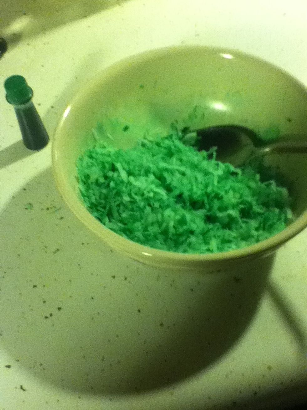Put a few drops of food coloring into a bowl of shredded coconut.