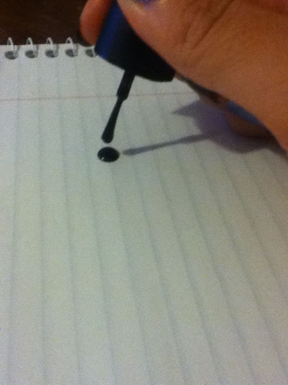Put a few drops of the dark polish onto the piece of paper.