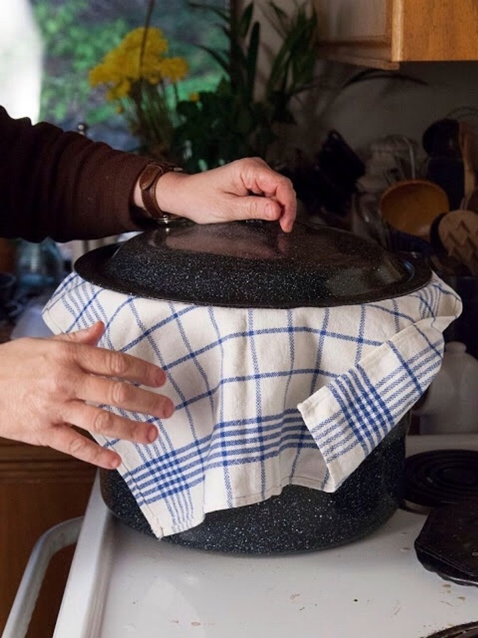 Put a lid on the pot. Wrap the sides of the towel around the top of the pot. Steam the bread for about 12 minutes.