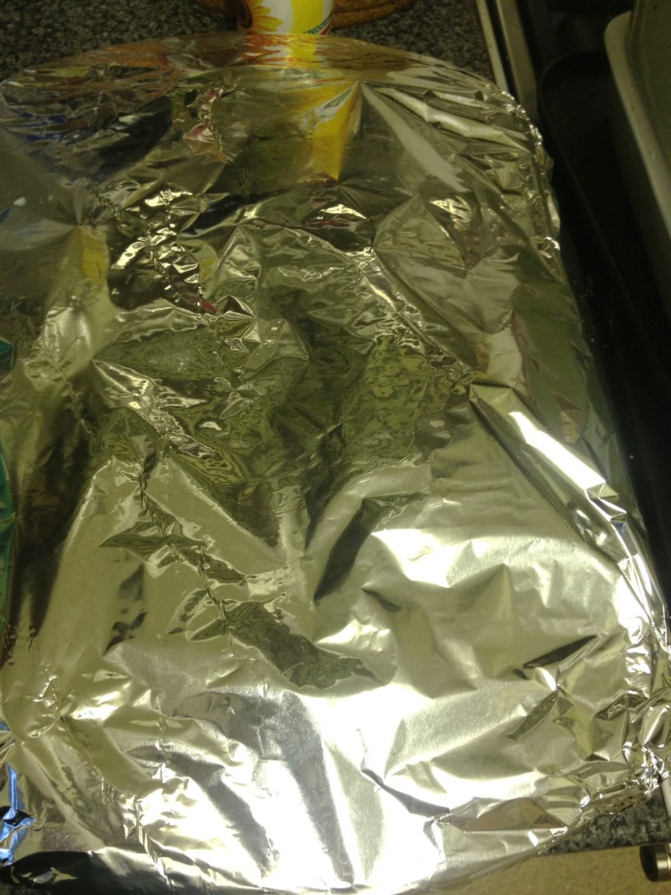 Put a lid or foil on your tray and put in the oven. Set 180 degrees and check after half an hour if the potatoes are soft enough. Then remove the foil/lid and cook for another 15min.