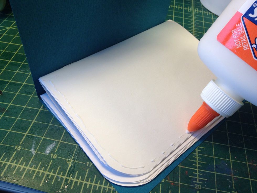 Put a line of glue around the first page.