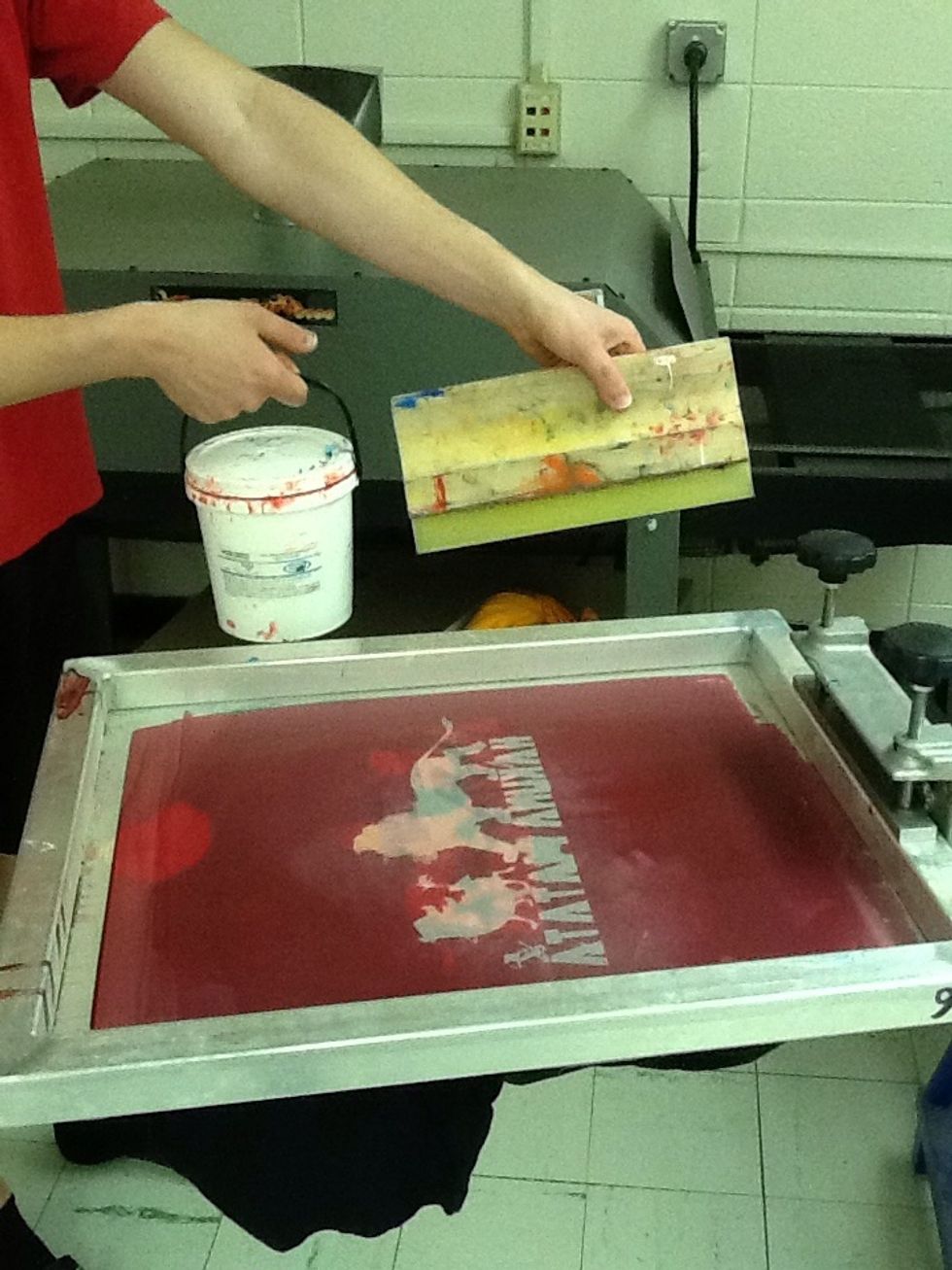 Put a line of ink on the lower half of the screen horizontally. Use the squeegee to run the ink up and down the screen.