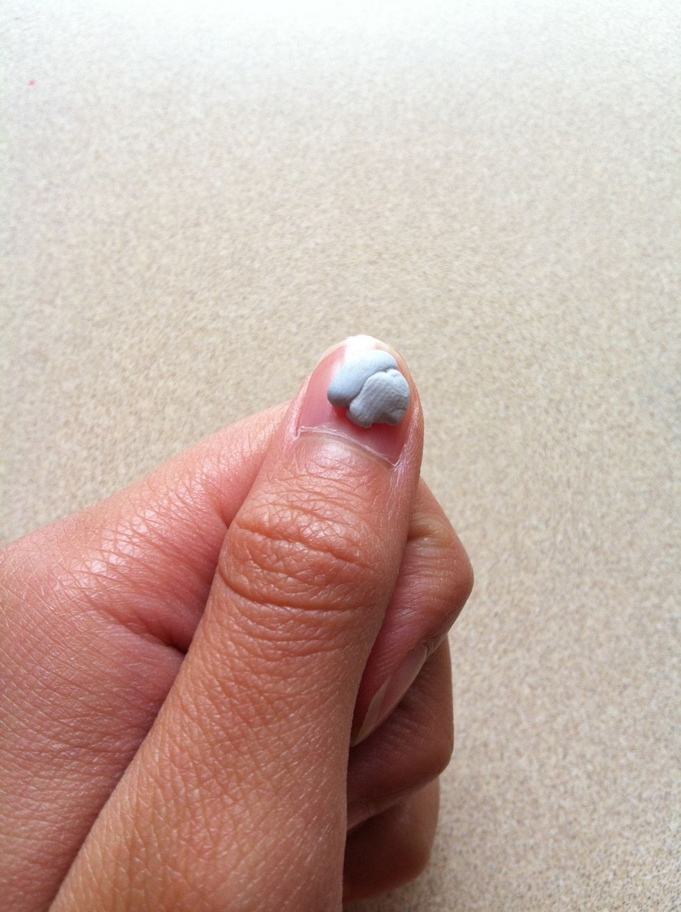 Put a little bit of blue tack or double sided tape on your thumb