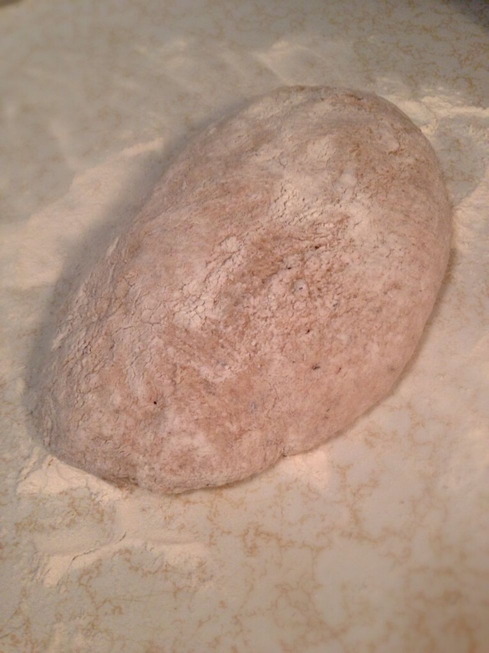 Put a little bit of flour on your counter and hands, so it doesn't stick. Pour the dough on the counter and start folding in from the outside just till the whole outside is covered with flour.